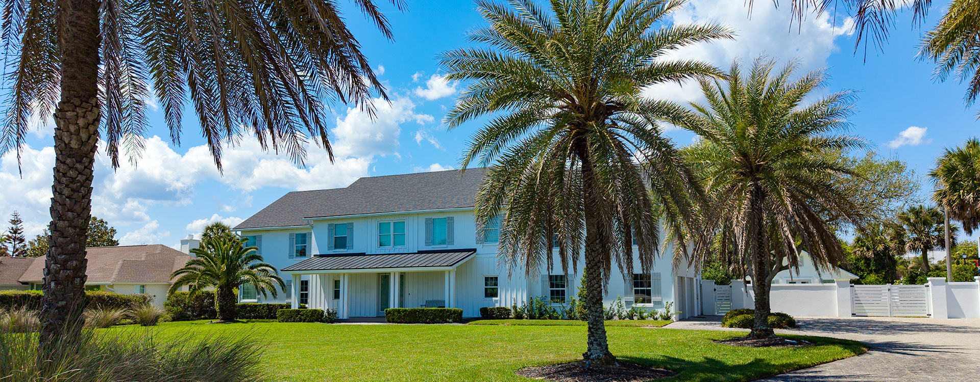 Front exterior of a Ponte Vedra home framed by palm trees